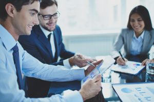 co-workers reviewing reports of a development audit