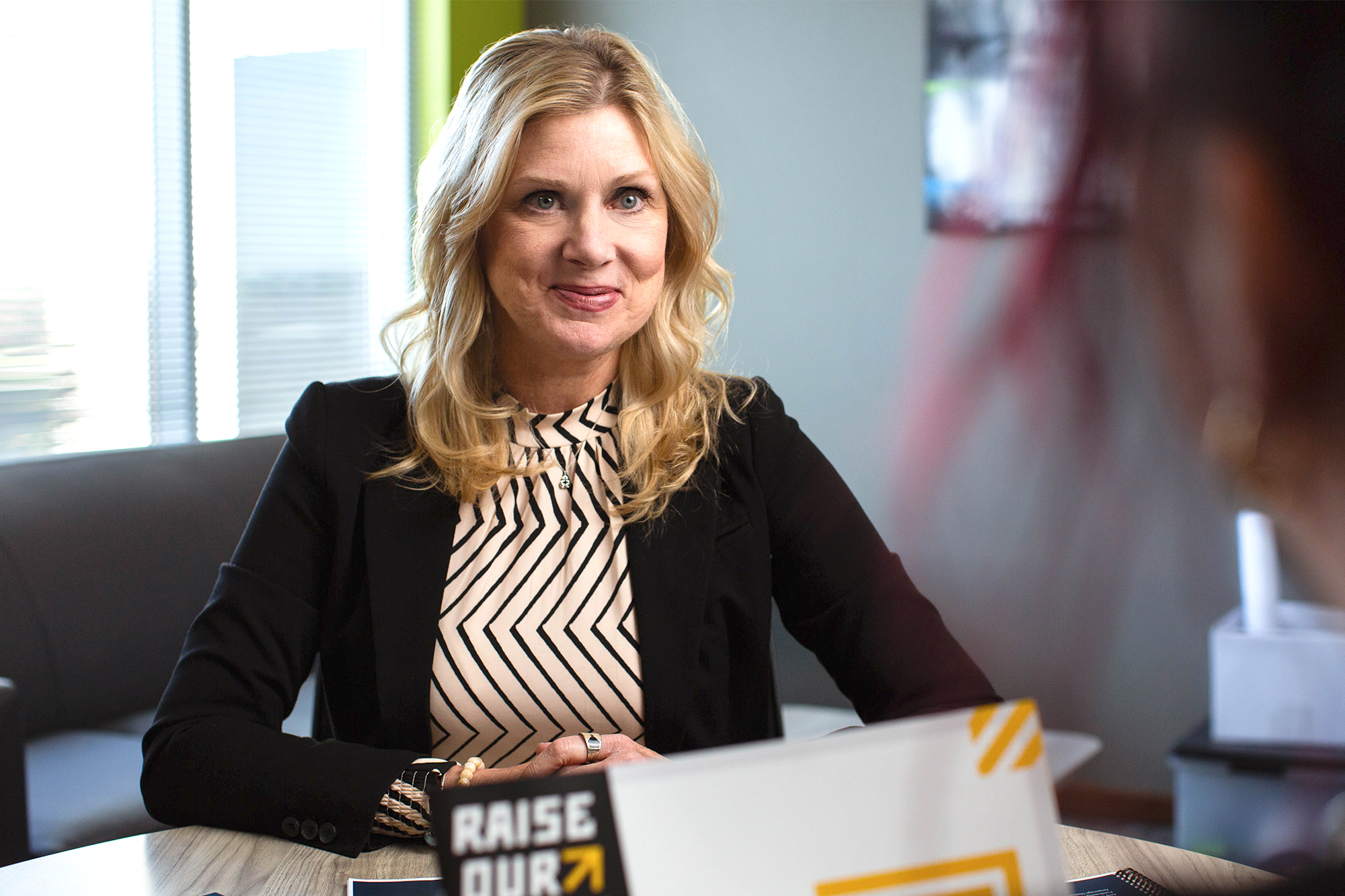 Kristin an Amperage Fundraising Adviser sits at desk