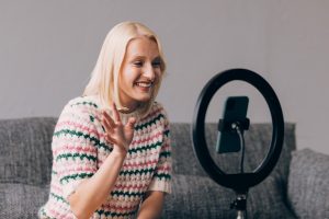 Presenter waving at camera.